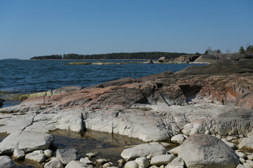 Helsinki archipelago island Pihlajasaaren with woods, trees, rocky sandy beaches and spectacular bay views of downtown skyline and other channel islands with beautiful serene nature landscape scenery