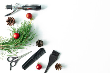 Christmas hairdresser accessories with combs, brush, scissors, tools with new year decorations on white background. Stylish concept. Flat lay, top view with copy space