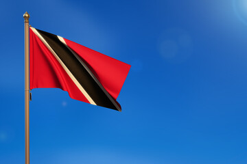 Trinidad and Tobago. Flag blown by the wind with blue sky in the background.