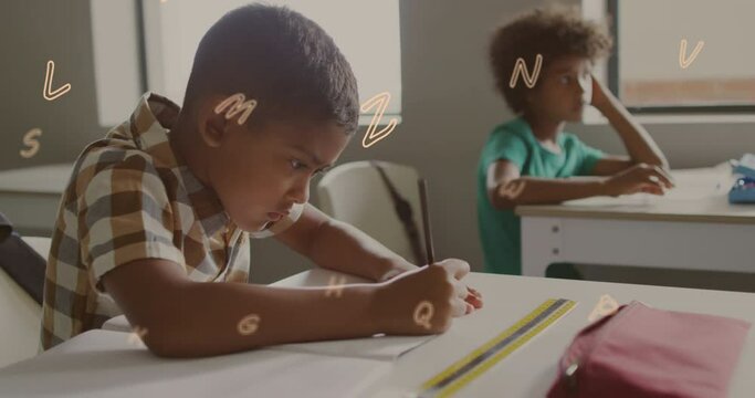 Animation of letters floating over bust african american schoolboy writing at desk in class