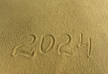 Numbers 2024 on the sea sand. There is space for text.