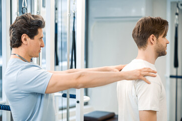 Manual therapist working with a patient in rehabilitation center