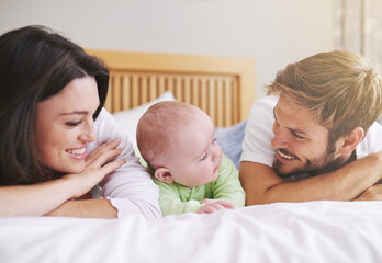 Fototapeta na wymiar Mother, father and baby relax on bed for love, care and fun quality time together at home. Happy family, parents and newborn bonding in bedroom for support, happiness or nurture childhood development