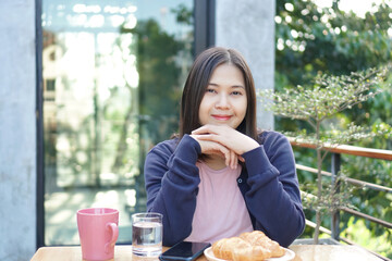 Asian woman relaxing in a cafe. - 602916089