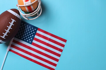 Rugby ball with national flag of USA on blue background with copy space
