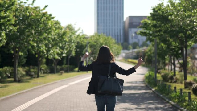 喜ぶビジネスウーマンの後ろ姿