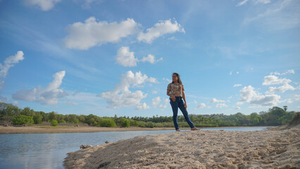 Obraz premium a woman enjoying the beauty of the beach