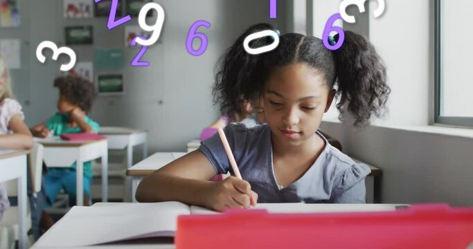 Animation of numbers over happy biracial schoolgirl writing at desk in class