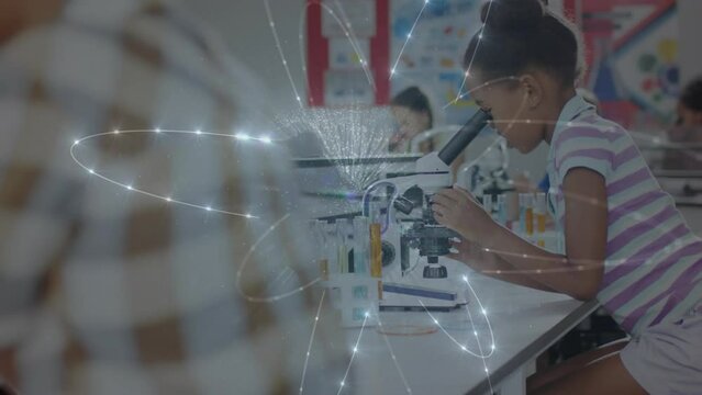 Animation of glowing network over biracial schoolgirl using microscope in science class