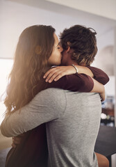 Couple, hug and kiss in home for love, care and bonding for quality time together with trust,...