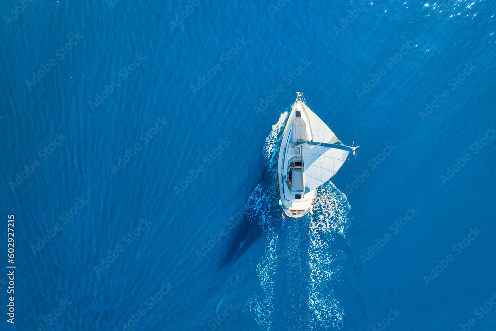 Wall mural wave and sail yacht on the sea as a background. .sea and waves from top view. blue water background 