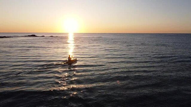 Kayak at the beach drone view. Kayaker trolling fishing from aerial point of view at Mediterranean sea