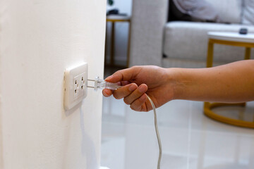 Hand insert a plug into socket.