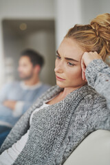 Sad, depression and woman in conflict with her boyfriend in the living room of their apartment....