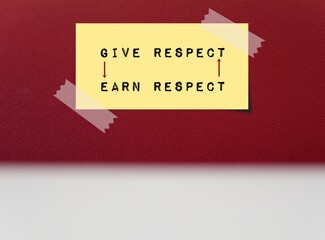 note on red copy space background written GIVE RESPECT EARN RESPECT with direction arrows, means...