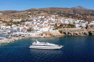 Fototapeta na wymiar Andros island, Batsi village Cyclades Greece. Aerial drone view of building, port, yacht, sea, sky.
