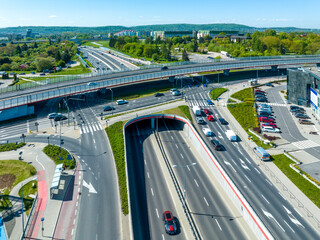 Multilevel city highway junction in Krakow, Poland. One highway on the top level, the second one in the tunnel, the turnaround with traffic lights and zebra crossings on the middle level. Aerial view - 602934033