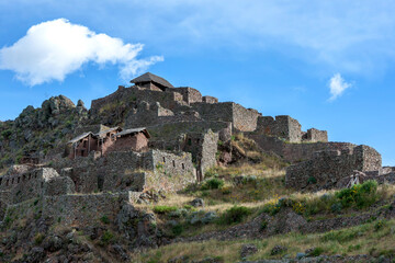 The ancient ruins of Pisac in the Sacred Valley in Peru in the late afternoon. Pisac is best known for these Incan ruins, known as Inca Pisac, which lie atop a hill at the entrance to the valley. 