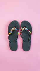 pair of flip flops isolated on pink background. Close-up of beach slippers. Future vacation. blank...