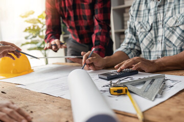 engineer working in office with blueprints, inspection in workplace for architectural plan, construction project ,Business construction