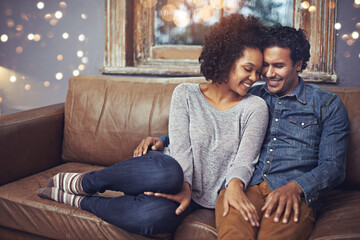 Hug, love and happy couple relax on a sofa, romantic and bonding on date night with bokeh....