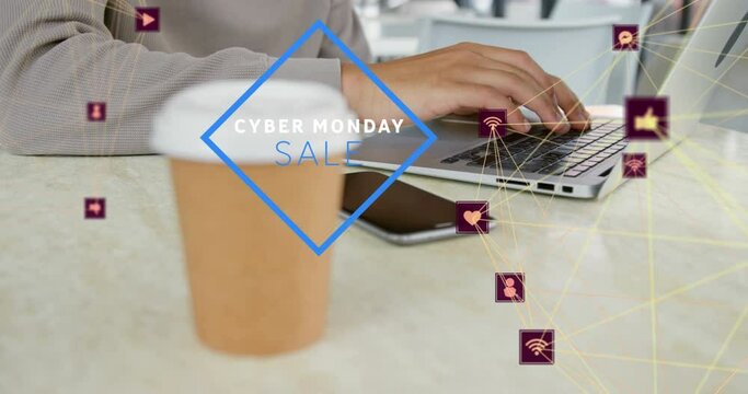 Animation of cyber monday sale text, connected icons, midsection of biracial man working on laptop