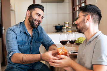 brazilian gay man receiving gift box from partner at home