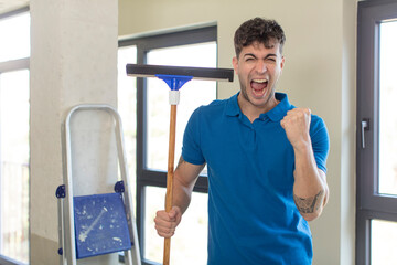 young handsome man looking angry, annoyed and frustrated. windows washer concept