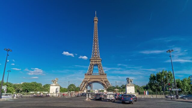 Eiffel Tower with traffic on a bridge over Siene river in Paris timelapse hyperlapse, France. Blue cloudy sky at summer day with green trees and car traffic on intersection
