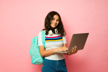 Beautiful teen girl using her laptop at junior high shcool
