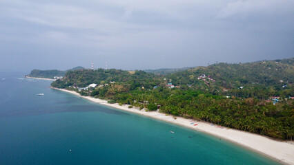 Long sandy beach along the sea. Aerial view of a sandy beach and a small town on the coast.