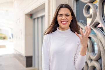 pretty young adult woman looking angry, annoyed and frustrated screaming wtf or what’s wrong with...