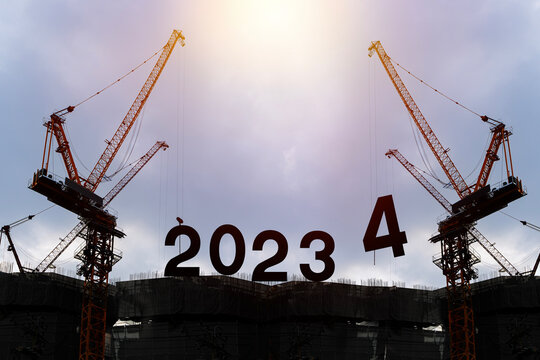 Silhouette of construction worker with crane and cloudy sky for preparation of welcome 2024 new year party and change new business.