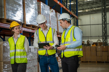 Warehouse worker checking packages on shelf in a large store,Logistics worker storing package boxes.