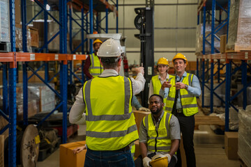 Portrait of warehouse workers are meeting together,Group of multicultural logistics employees working as a team in a large distribution centre.
