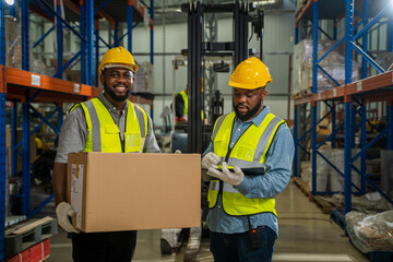 Warehouse worker checking stock products in a large distribution warehouse.,Warehousing, Logistics in stock.