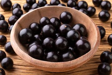 Jabuticabas on a bowl over wooden table