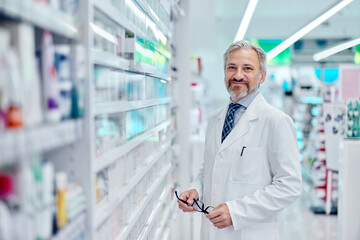 Portrait of an adult male pharmacist, posing for the camera, smiling.