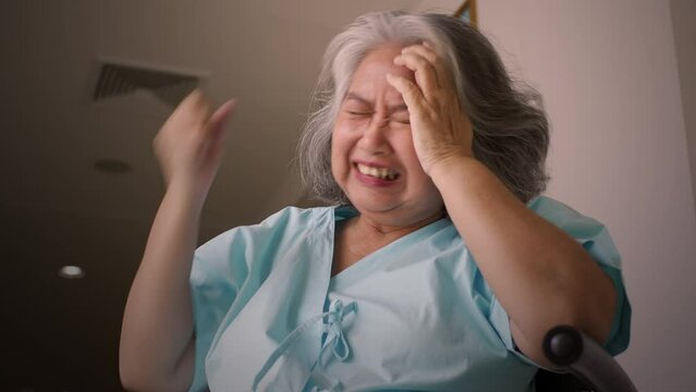 Asian senior adult woman suffering from a mental disorder breakdown sickness, mental disorder concept, negative emotion, Alzheimer, depression and difficult life situation concept