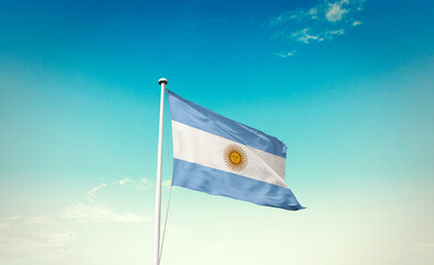 Waving Flag of Argentina in Blue Sky. The symbol of the state on wavy cotton fabric.