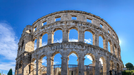 Obraz premium Panorama View of Pula Arena with Arch Window. Beautiful Roman Amphitheater in Croatia. Historic Landmark in Europe.