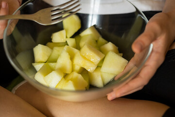 girl eat Muskmelon on the couch