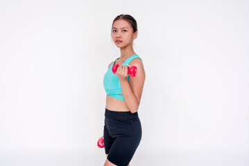 Naklejka premium A healthy and focused woman weightlifting and working out using a dumbbell, side view. Isolated on a white background.