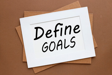 black font on white paper .framed text define goals