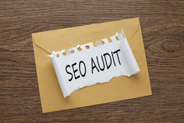 torn paper with SEO AUDIT text. business concept. on the envelope