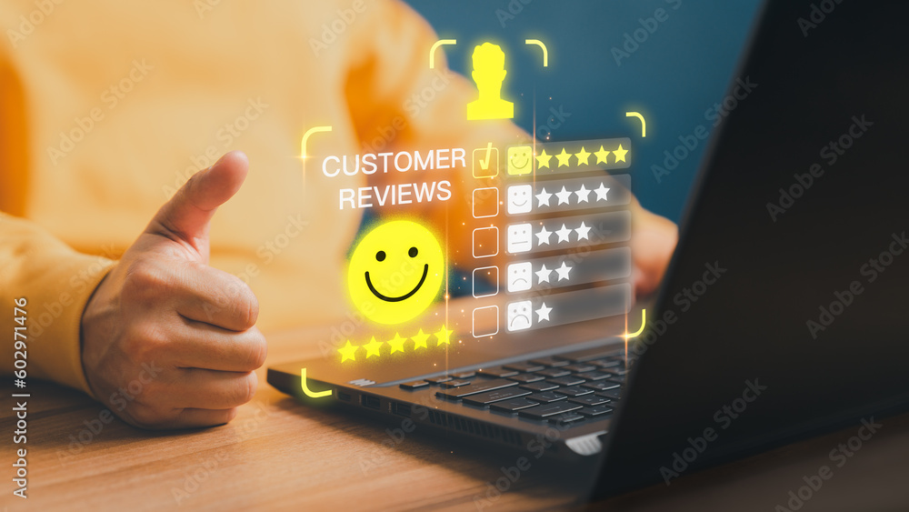 Poster user hand using a computer laptop with pop up smiley face and five star icon for assessment feedback