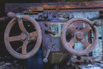 Old rusty machines in an abandoned factory.