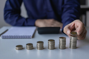 Concepts of financial accounting management in the future, income and expenses, savings and investment management concepts. Key things to consider when planning with stacks of coins