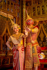 Vertical image of beautiful Asian woman wear Thai traditional dress action of dancing together with...
