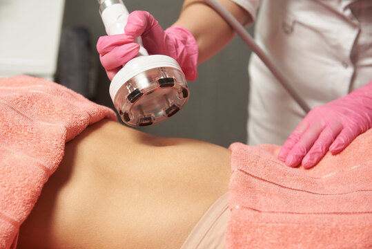 Vacuum massage on a woman's stomach close-up